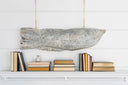 A hand-carved wooden cod fish hanging over the mantel at Laughing Gull Hill